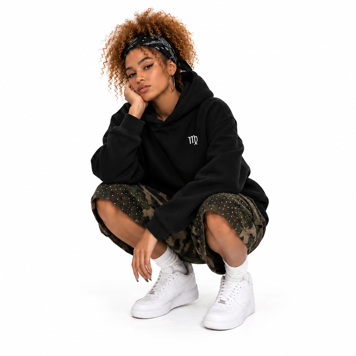 Crouched front view of the black Virgo hoodie, square image